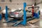 Silver used car stands on the stand wheel alignment convergence of the car in the workshop for repair of vehicles. Auto service