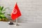 Silver vintage bell with national flag of Tunisia on reception desk with copy space. Hotel service. Travel, tourism. Africa. Conce