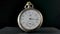 Silver vintage pocket watch with hands running in circle in timelapse video. Old pocket watch with round dial and