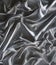 Silver wrinkled satin fabric background showing progress in a curve