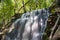 Silverfallet Staircase Waterfall illuminated by low rays of sun