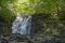 Silverfallet Staircase Waterfall illuminated by low rays of sun