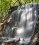 Silverfallet staricase Waterfall in Lush forest and rural mill environment