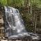 Silverfallet staricase Waterfall in Lush forest and rural mill environment