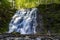 Silverfallet staricase Waterfall in Lush forest and rural mill environment