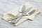 Silverware and hemstitch napkin on antique carrara marble