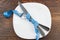 The silverware, plate and measuring tape, wooden background