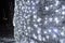 Silvery background of Christmas decorations, lanterns, lights, garlands, rain arched.