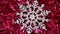 A silvery snowflake lies on New Year`s red tinsel and slowly moves clockwise. Christmas winter background. Happy New Year