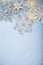 Silvery snowflakes on a wooden background.