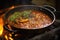 simmering the masala sauce in a traditional kadai