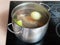 Simmering meat broth in stockpot on ceramic cooker