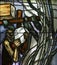 Simon of Cyrene carries the cross, detail of stained glass window in Chapel in the Jesuit cemetery in Pullach,