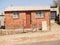 Simple architecture of small home on dusty street