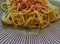 Simple bachelor dinner of spaghetti with tomato sauce, spaghetti neapolitana on a wooden platter with lots of copy space