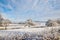 A simple background landscape with snow covered fields and distant trees half obscured by mist