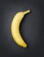 Simple banana on dark slate background.