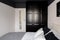 Simple bedroom with black wardrobe