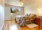 Simple bedroom with hardwood floor and fall window view.