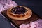 A simple blueberry pie on a wooden shelf. Homemade round cake. Sweet pastries, flour products cooked at home. Open pie with