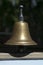 Simple brass bell on windowsill