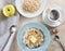 simple Breakfast - tea bags and oatmeal with butter, yellow Apple