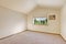 Simple bright ivory empty room with vaulted ceiling