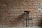 Simple chair with shadow cast on rustic brick and concrete wall pattern for industrial and minimalism design