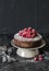 Simple chocolate cake with fresh raspberry on dark background. Delicious dessert