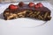 Simple chocolate cake, pie or flan made from quality chocolate english style bisquits and fresh raw strawberries