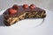 Simple chocolate cake, pie or flan made from quality chocolate english style bisquits and fresh raw strawberries