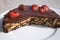 Simple chocolate cake, pie or flan made from quality chocolate english style bisquits and fresh raw strawberries