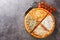 Simple classic pizza quattro formaggi with gorgonzola cheese, ricotta, parmesan and mozzarella close-up on a wooden board.