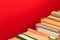 Simple composSimple composition of hardback ition of hardback books, raw of books on wooden deck table and red background - Image.