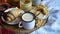 Simple country home breakfast in bed, coffee with milk and homemade pastry on plaid blanket