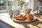 Simple yet delicious image of two croissants resting on cutting board, accompanied by steaming cup of coffee. Perfect fo