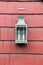 Simple design of lantern attached to red siding of home