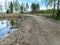 A simple dirt road, clay new and old grass, spring landscape