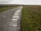 A simple dirt road, on a road puddle