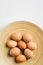 Simple Easter eggs on elegant plate on white background. Happy Easter concept