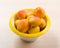 The simple food composition with apricot in the bowl on the unique backing closeup