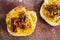 Simple food ingredients, bread slices with sweet potoato and kale dip topped with sundried tomatoes