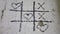 Simple game - X-O game.Hand drawn tic-tac-toe elements.Happy Valentines day symbol. Love graphite on old cracked wall