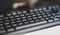 Simple generic black business office computer keyboard object detail, shallow dof, closeup, nobody. Abstract background, no people