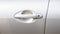 Simple generic silver car door handle with a key lock hole, side front view, object detail, closeup, vehicle doors handle frontal