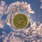 simple green tiny planet without buildings in blue sky with beautiful clouds. Transformation of spherical panorama 360 degrees.