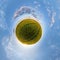 simple green tiny planet without buildings in blue sky with beautiful clouds. Transformation of spherical panorama 360 degrees.