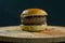 Simple hamburger on a wooden board dark background