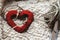 Simple handmade heart on unique cozy background with thread and