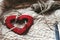 Simple handmade heart on unique cozy background with thread and